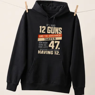 Bold typography t-shirt with humorous gun ownership statement in cream, red, and gray — printed on a unisex hoodie