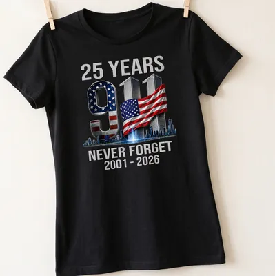 Bold graphic T-shirt commemorating 25 years since 9/11 with a strong message — printed on a women's shirt