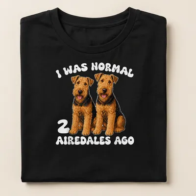 Realistic illustration of two Airedale dogs with humorous text about dog ownership. — printed on a women's shirt