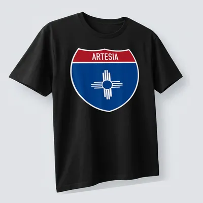 Bold graphic T-shirt featuring Arteisa highway sign in blue, red, and white — printed on a unisex t-shirt (angled view)