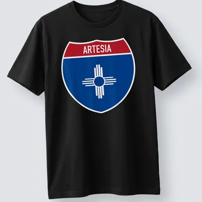 Bold graphic T-shirt featuring Arteisa highway sign in blue, red, and white
