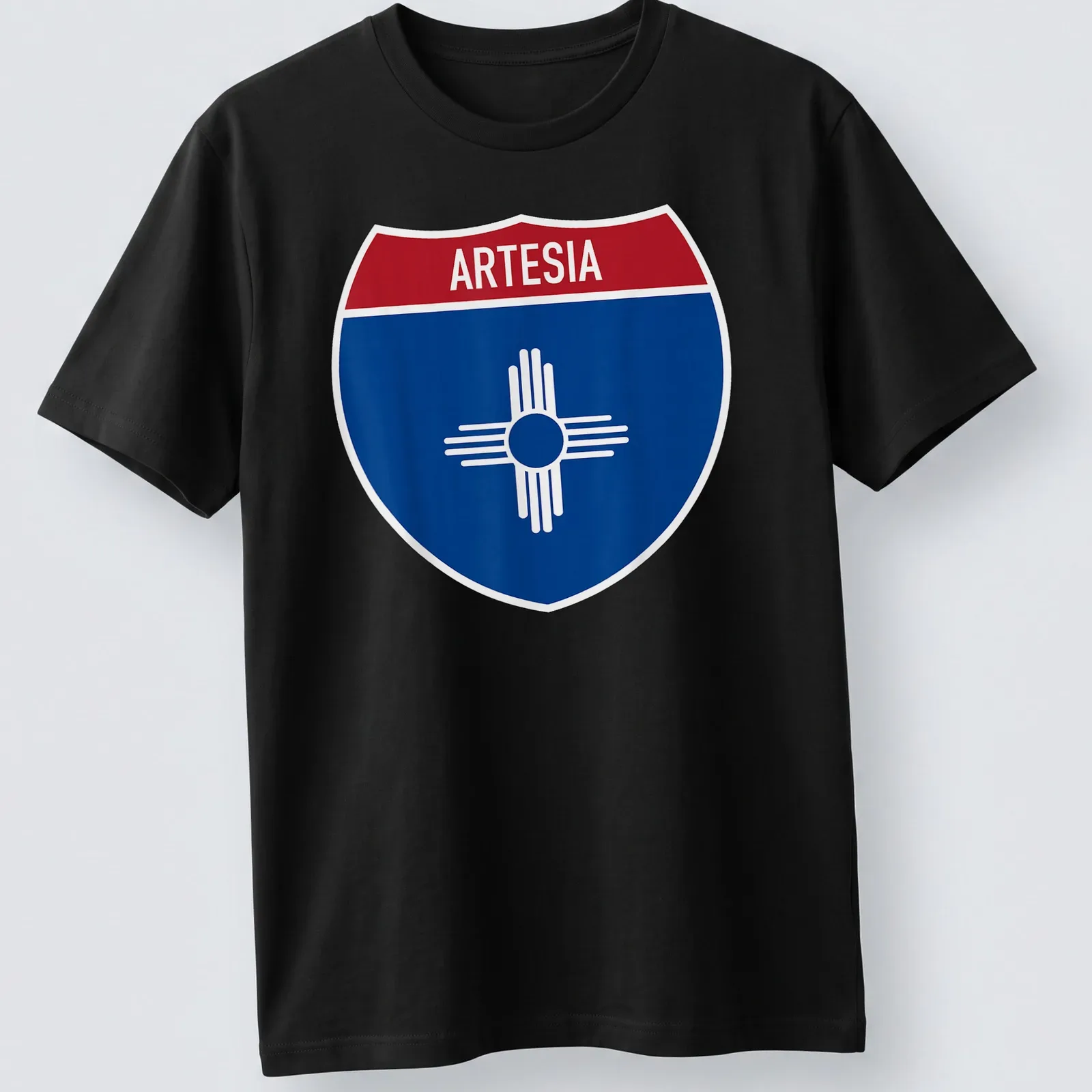 Bold graphic T-shirt featuring Arteisa highway sign in blue, red, and white — printed on a unisex t-shirt