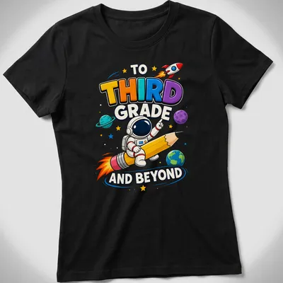Colorful cartoon astronaut riding a giant pencil with playful text above — printed on a women's shirt