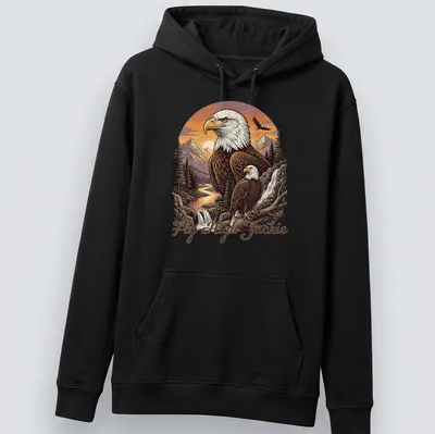 Illustration of a Bald Eagle flying over a mountain scene with the text Fly High Jackie — printed on a unisex hoodie