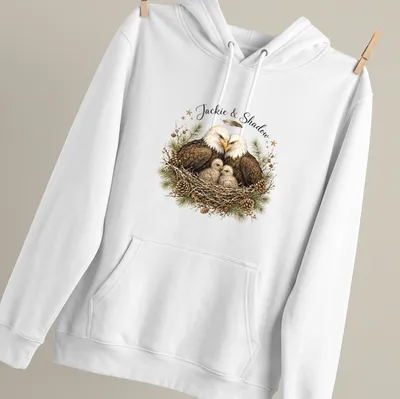 Realistic illustration of two bald eagles named Jackie and Shadow on a natural background — printed on a unisex hoodie