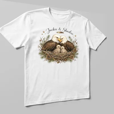 Realistic illustration of two bald eagles named Jackie and Shadow on a natural background — printed on a unisex t-shirt (angled view)