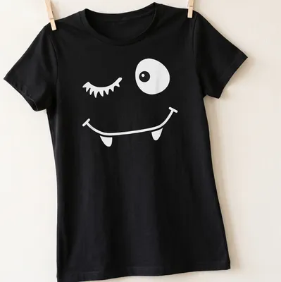 Cartoon winking face with bat eyelashes in black and white — printed on a women's shirt