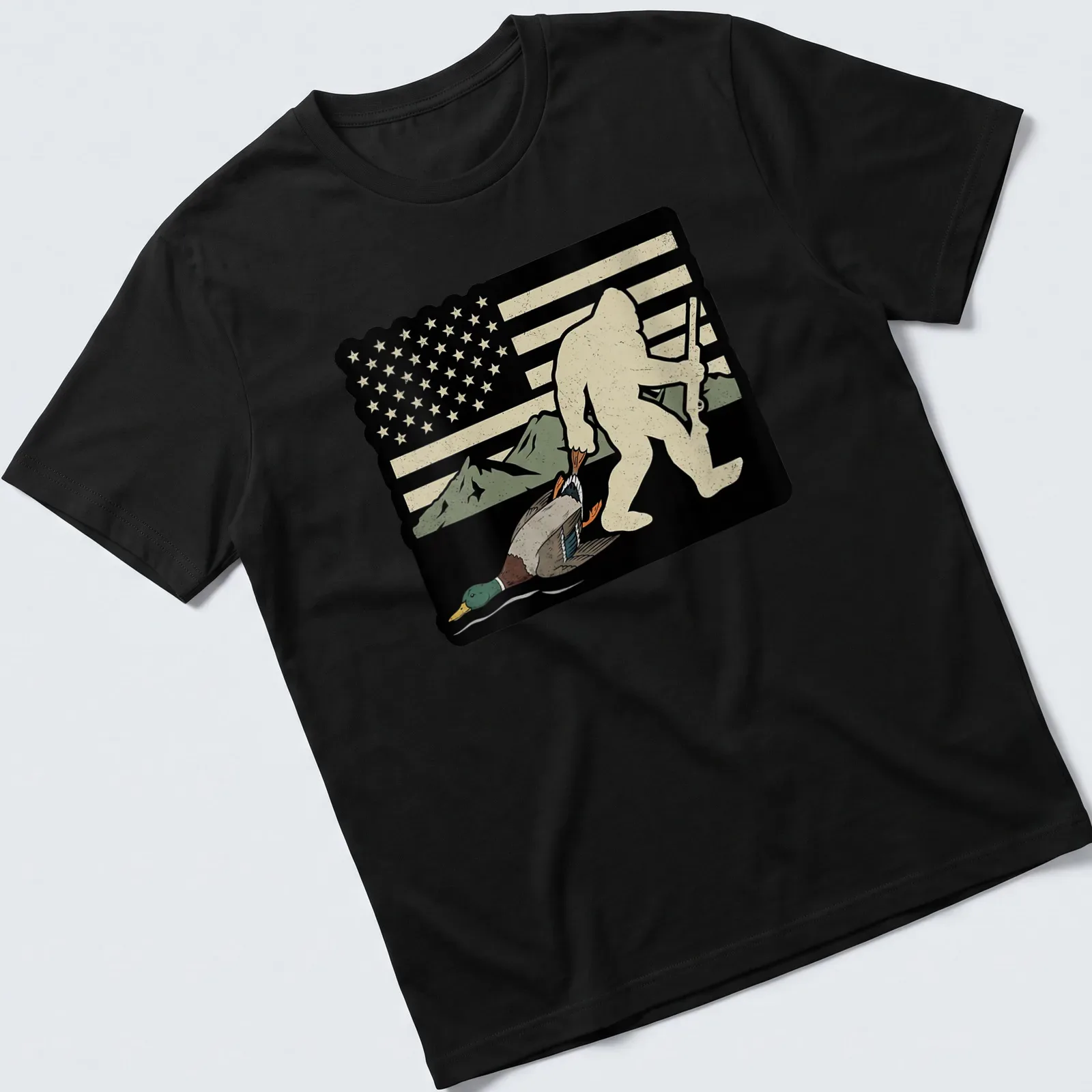 Whimsical Bigfoot carrying a duck with American flag elements in vintage style — printed on a unisex t-shirt