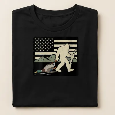 Whimsical Bigfoot carrying a duck with American flag elements in vintage style — printed on a women's shirt