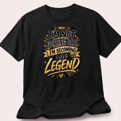 Bold typography t-shirt with the text I'm Not Getting Old, I'm Becoming a Legend in black, gold, and white.