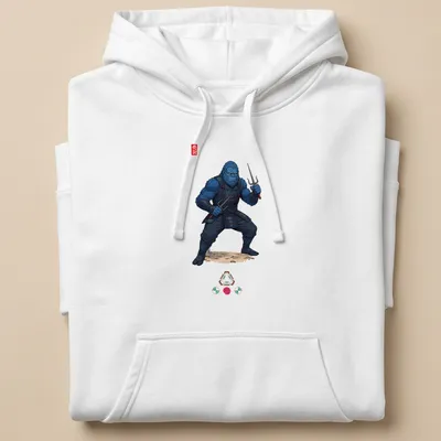 Illustration of a blue Bigfoot ninja wielding sai weapons with the word 'Ninja' — printed on a unisex hoodie