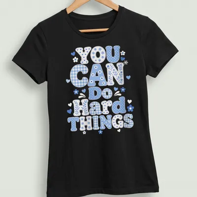 Playful blue patchwork design with the phrase 'You Can Do Hard Things' — printed on a women's shirt