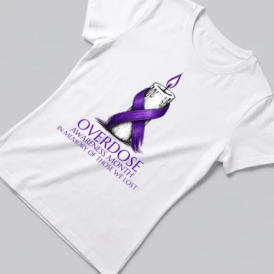 Illustration of a candle with a purple ribbon and text for overdose awareness — printed on a women's shirt