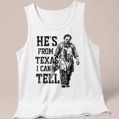 Vintage horror tee featuring a chainsaw character with the text 'He's from Texas I can tell' — printed on a tank top
