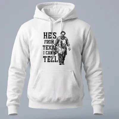 Vintage horror tee featuring a chainsaw character with the text 'He's from Texas I can tell' — printed on a unisex hoodie