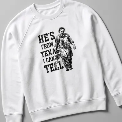 Vintage horror tee featuring a chainsaw character with the text 'He's from Texas I can tell' — printed on a unisex sweatshirt