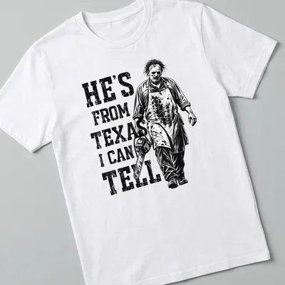 Vintage horror tee featuring a chainsaw character with the text 'He's from Texas I can tell'