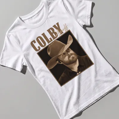 Sepia tone Colby Acuff t-shirt featuring an illustration of him in a cowboy hat — printed on a women's shirt