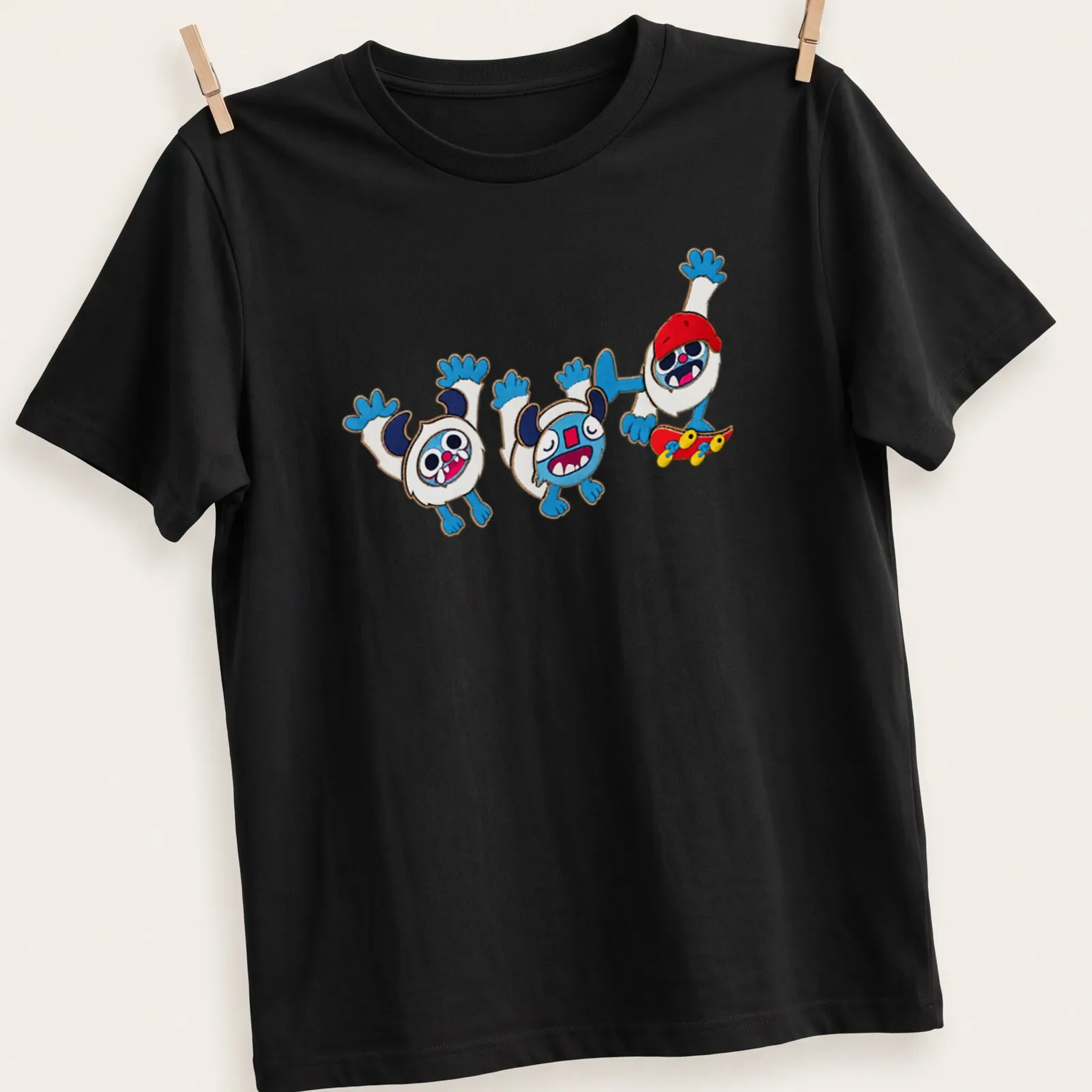 Kawaii cartoon yetis skating with colorful text reading Radical Yetis — printed on a unisex t-shirt
