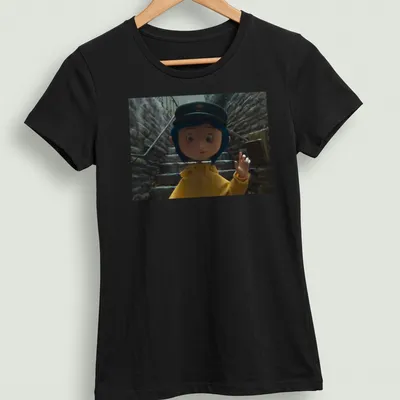 Coraline in a yellow raincoat surrounded by a whimsical background in 3D animation style — printed on a women's shirt