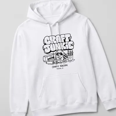 Cartoon raccoon graphic with text 'CRAFT JUNKIE CRAFTY RACOON PAHOA, HI' in black and white — printed on a unisex hoodie