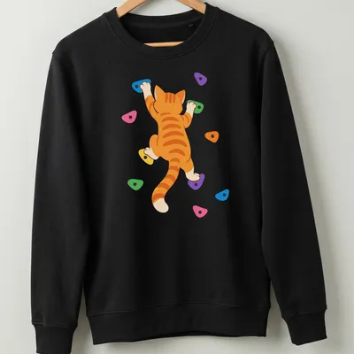 Kawaii-style orange tabby cat rock climbing illustration with vibrant colors — printed on a unisex sweatshirt