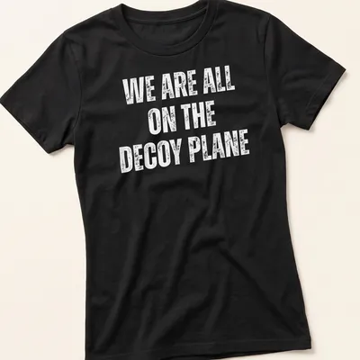 Bold typography on a t-shirt with the slogan 'WE ARE ALL ON THE DECoy PLANE' in white. — printed on a women's shirt