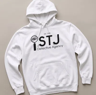 Modern minimalist Detective Agency t-shirt featuring magnifying glass and eye design in black and white — printed on a unisex hoodie