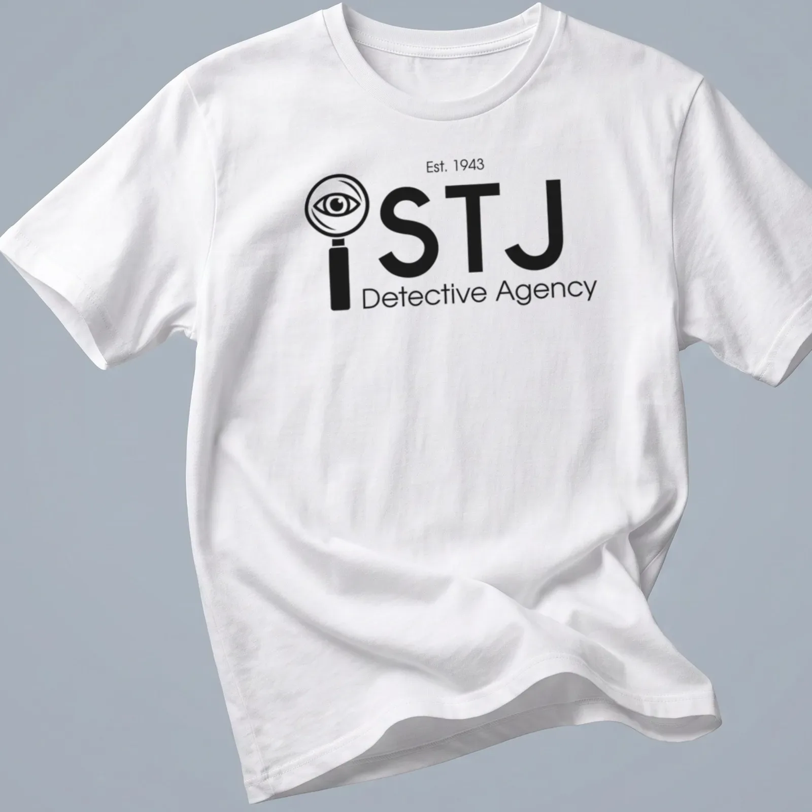 Modern minimalist Detective Agency t-shirt featuring magnifying glass and eye design in black and white — printed on a unisex t-shirt