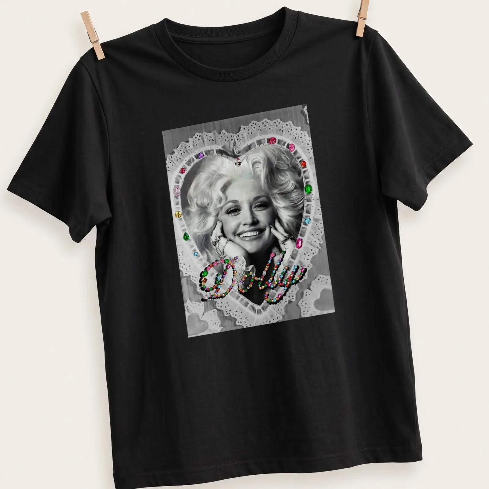 Vintage glam Dolly Parton t-shirt with colorful heart design around the name. — printed on a unisex t-shirt