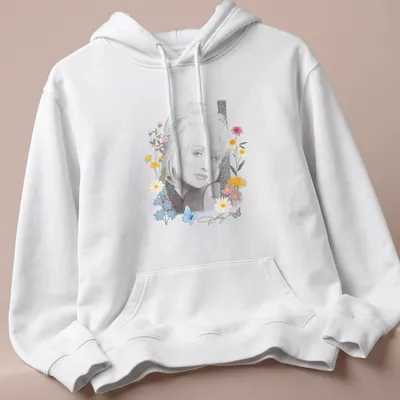 Portrait of Dolly Parton surrounded by flowers and butterflies in vibrant colors — printed on a unisex hoodie