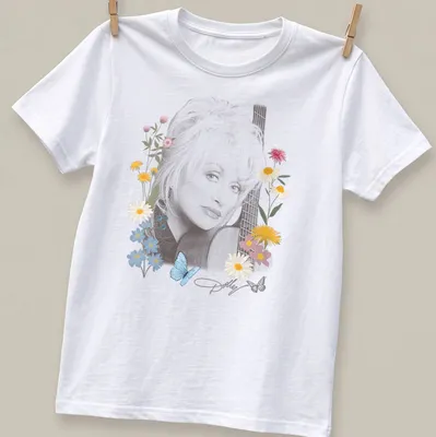 Portrait of Dolly Parton surrounded by flowers and butterflies in vibrant colors