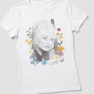 Portrait of Dolly Parton surrounded by flowers and butterflies in vibrant colors — printed on a women's shirt