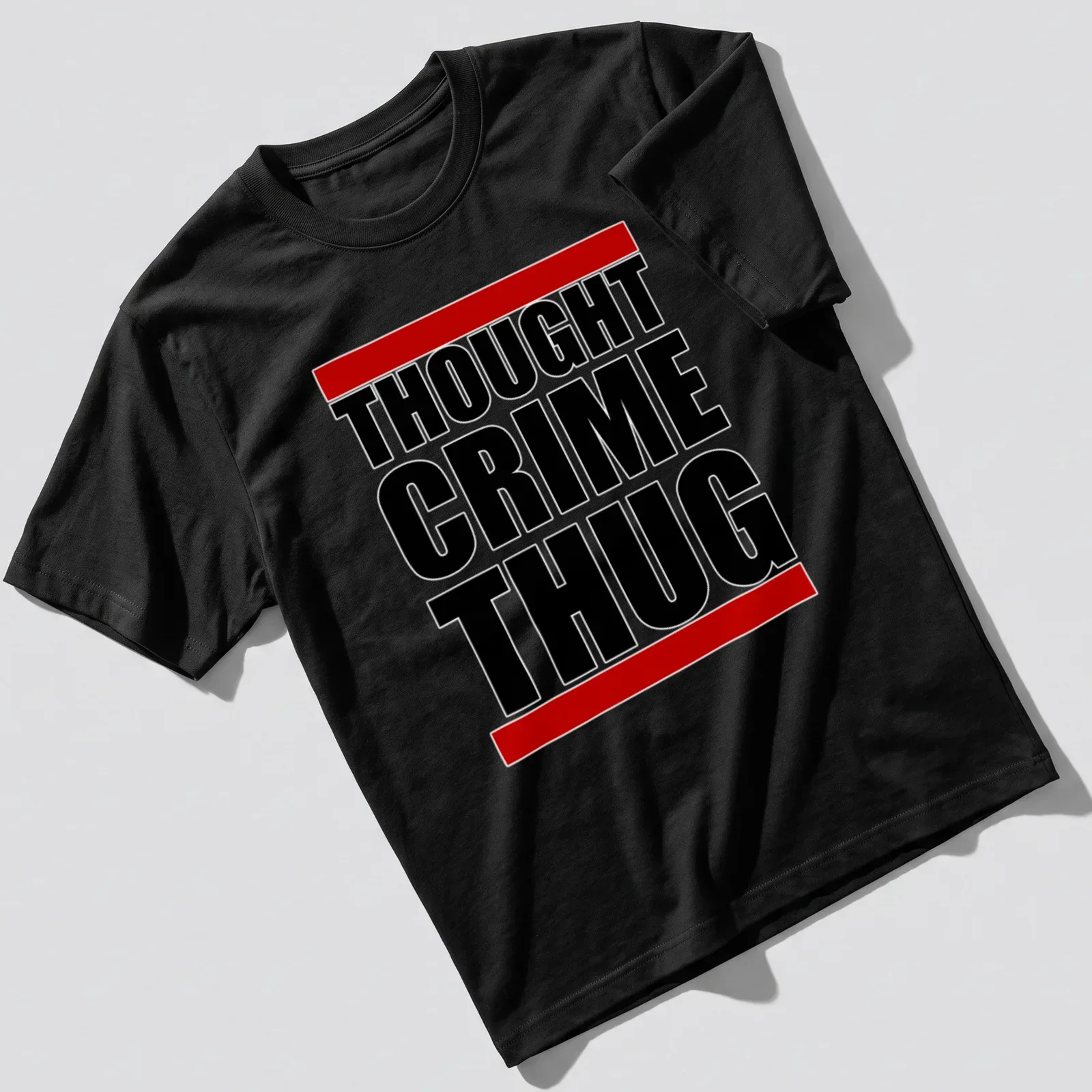 Dystopian themed tee with bold black, red, and white typography reading 'THOUGHT CRIME THUG' — printed on a unisex t-shirt