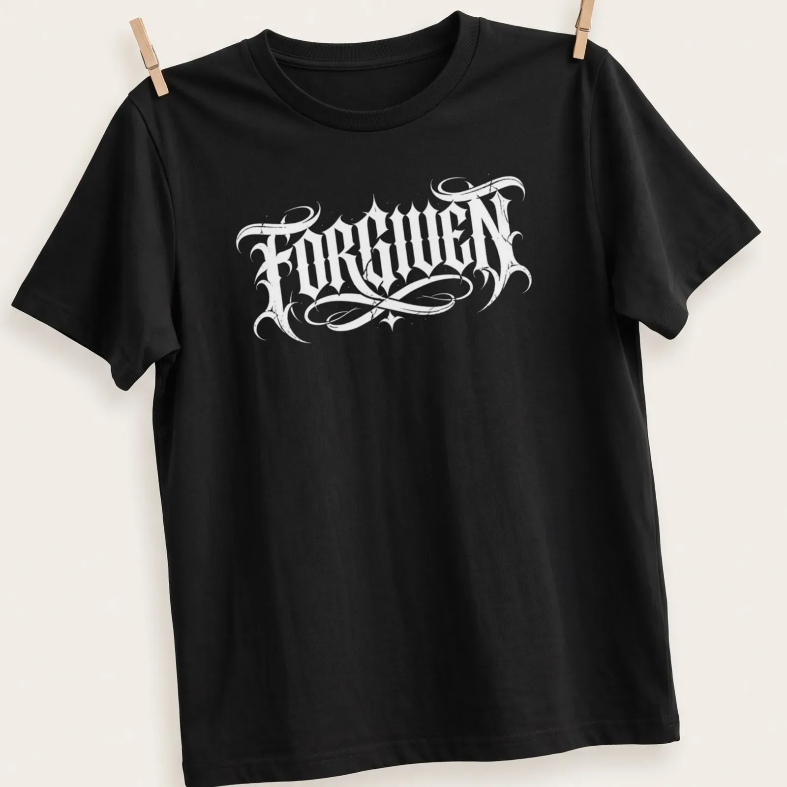 Bold black Gothic text reading FORGIVEN on a white t-shirt. — printed on a unisex t-shirt