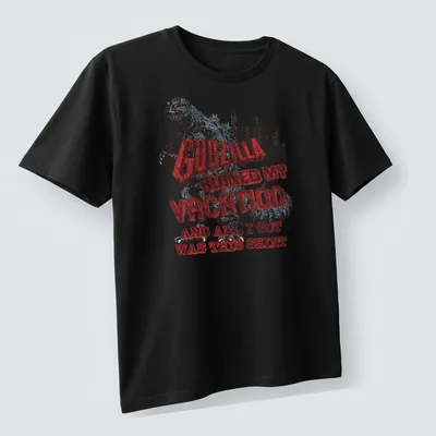 Vintage distressed Godzilla-themed T-shirt with humorous vacation text — printed on a unisex t-shirt (angled view)