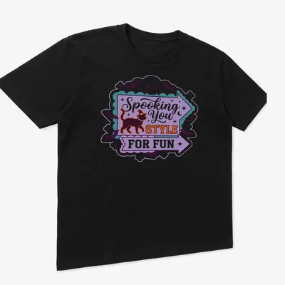 Playful Halloween-themed t-shirt featuring a black cat in a witch hat with colorful text. — printed on a unisex t-shirt (angled view)