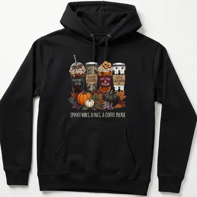 Whimsical illustration of Halloween-themed coffee cups with text about spooky vibes — printed on a unisex hoodie