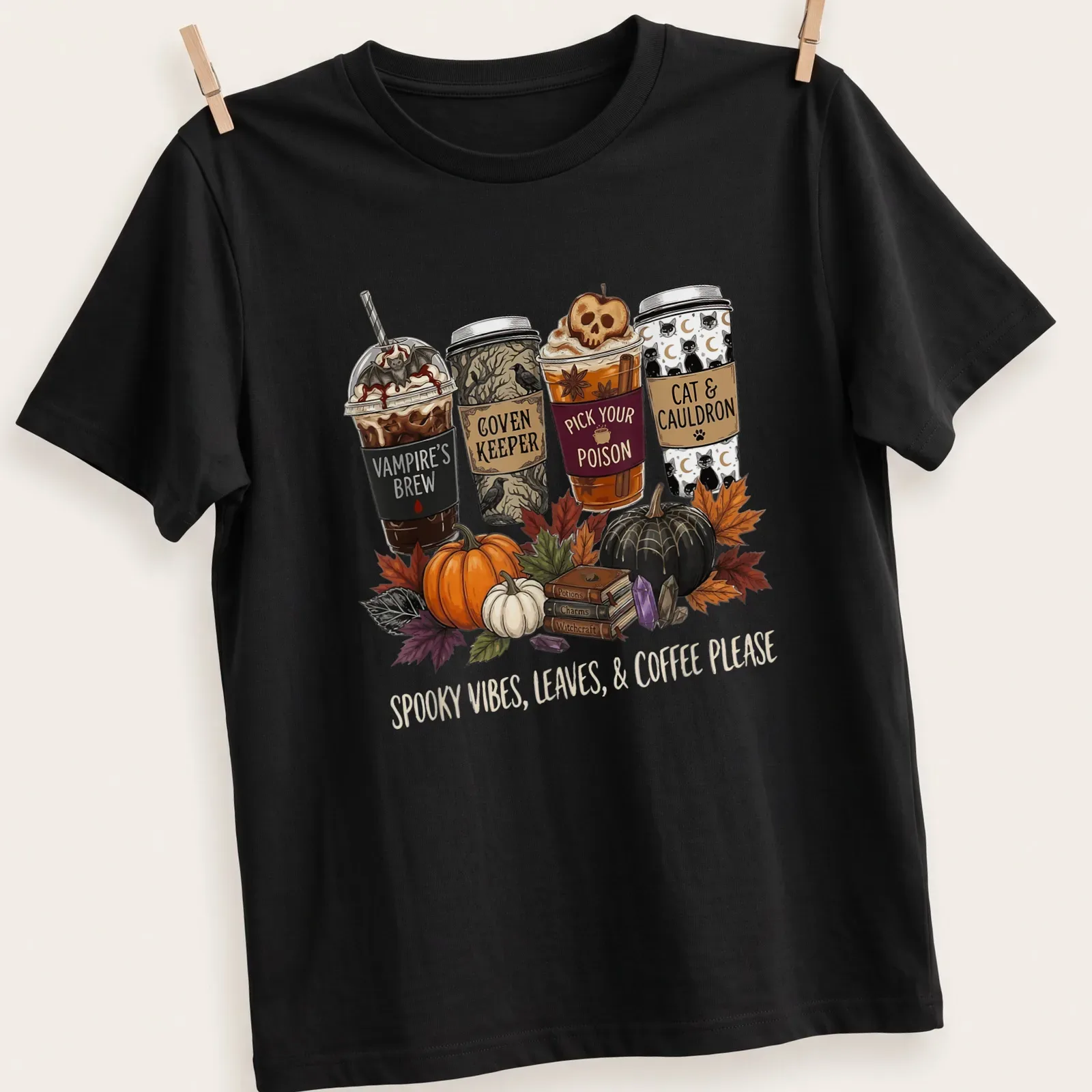 Whimsical illustration of Halloween-themed coffee cups with text about spooky vibes — printed on a unisex t-shirt