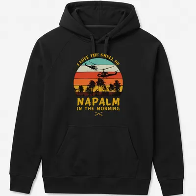 Retro sunset design with helicopters and bold text about napalm smell — printed on a unisex hoodie