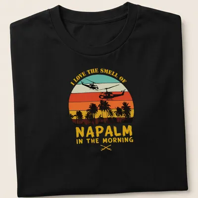 Retro sunset design with helicopters and bold text about napalm smell