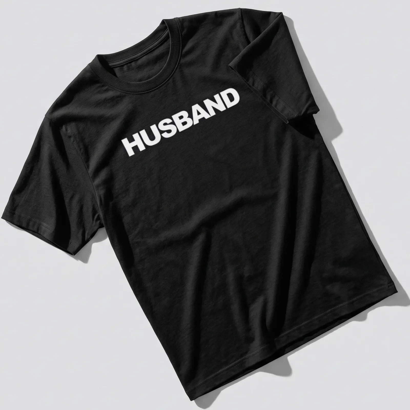 Bold typographic statement t-shirt with the word Husband in white. — printed on a unisex t-shirt