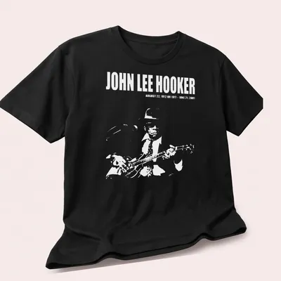 Vintage portrait of John Lee Hooker with text about his life dates in black, white, and gray. — printed on a unisex t-shirt (angled view)