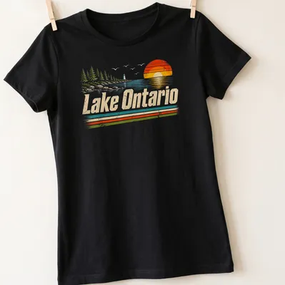 Retro vintage sunset graphic featuring Lake Ontario in warm colors — printed on a women's shirt