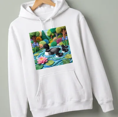Textured yarn art of a loon family on a lake with vibrant colors — printed on a unisex hoodie