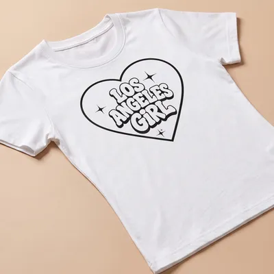 Bold black and white print of Los Angeles Girl with heart graphic — printed on a women's shirt