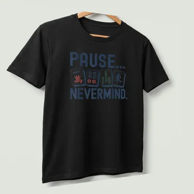 Playful Mahjong graphic tee with colorful Mahjong tiles and humorous text — printed on a unisex t-shirt (angled view)