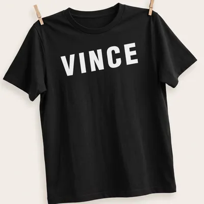 Bold typography t-shirt featuring the phrase The Color Of Money with money graphics in green, black, and white. — printed on a unisex t-shirt