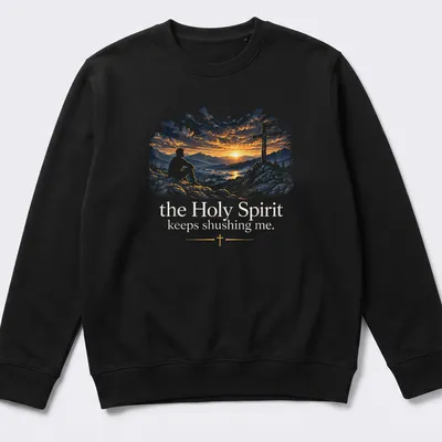 A serene illustration of a man on rocks at sunset with cross and text about the Holy Spirit — printed on a unisex sweatshirt
