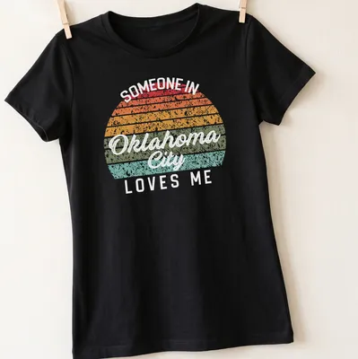 Retro distressed t-shirt with the phrase 'Someone in Oklahoma City Loves Me' in bright colors — printed on a women's shirt